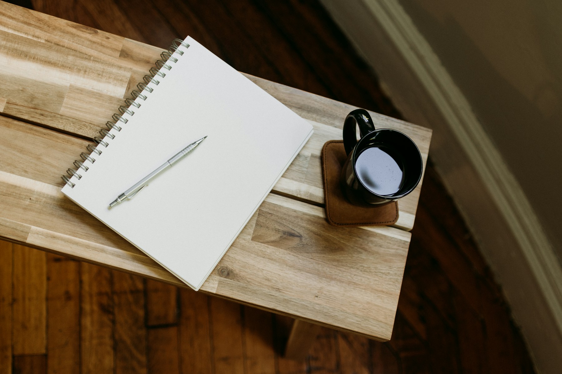 An open journal and pen in a quiet moment of natural light